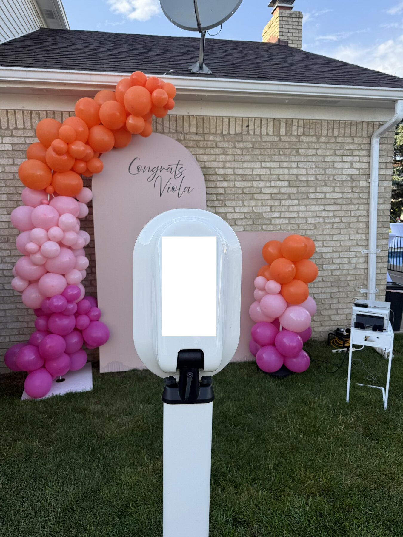 Guests enjoying the open-air photo booth at a graduation party